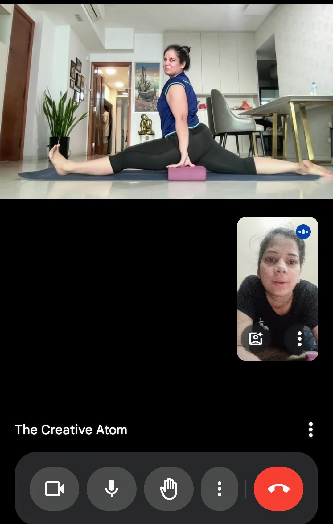 A student practicing Hanumanasana (the splits) in an online yoga class.