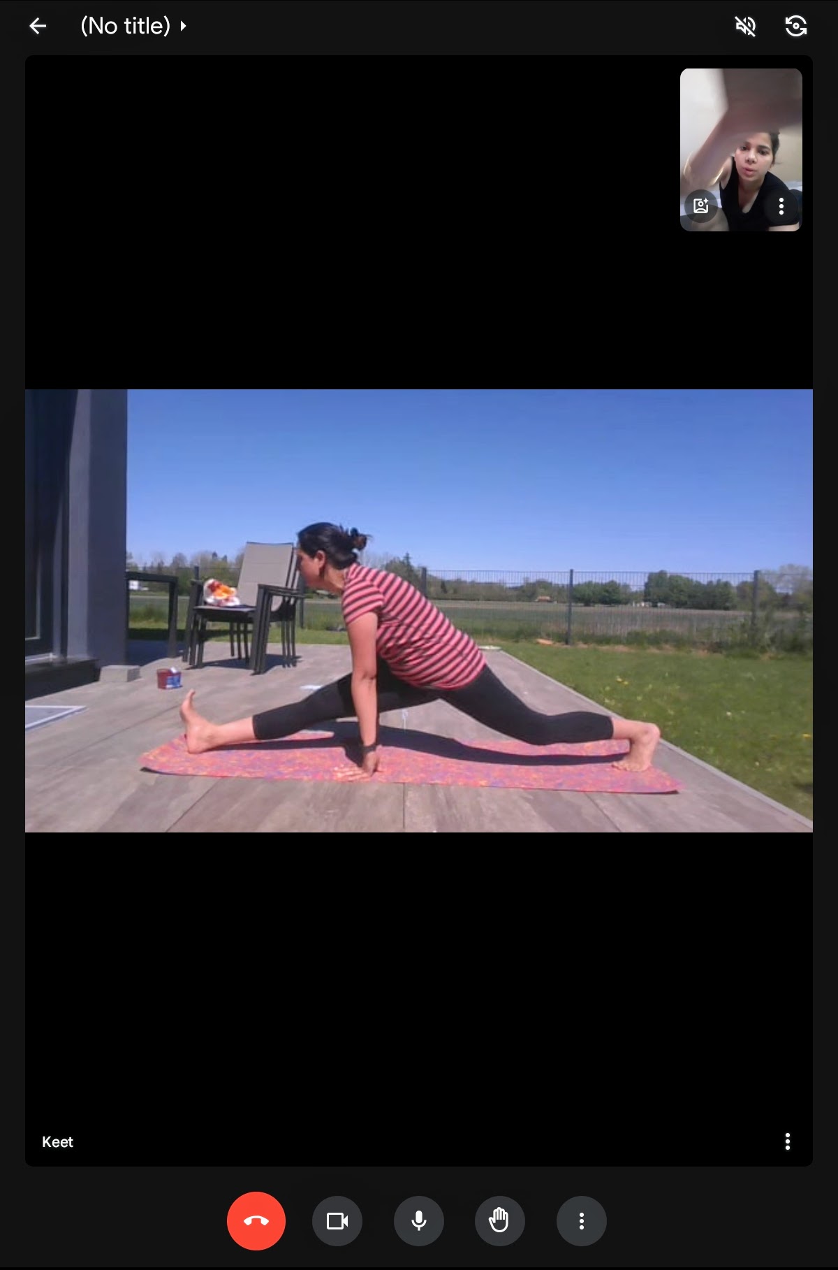 A student in a low lunge pose in an outdoor setting.