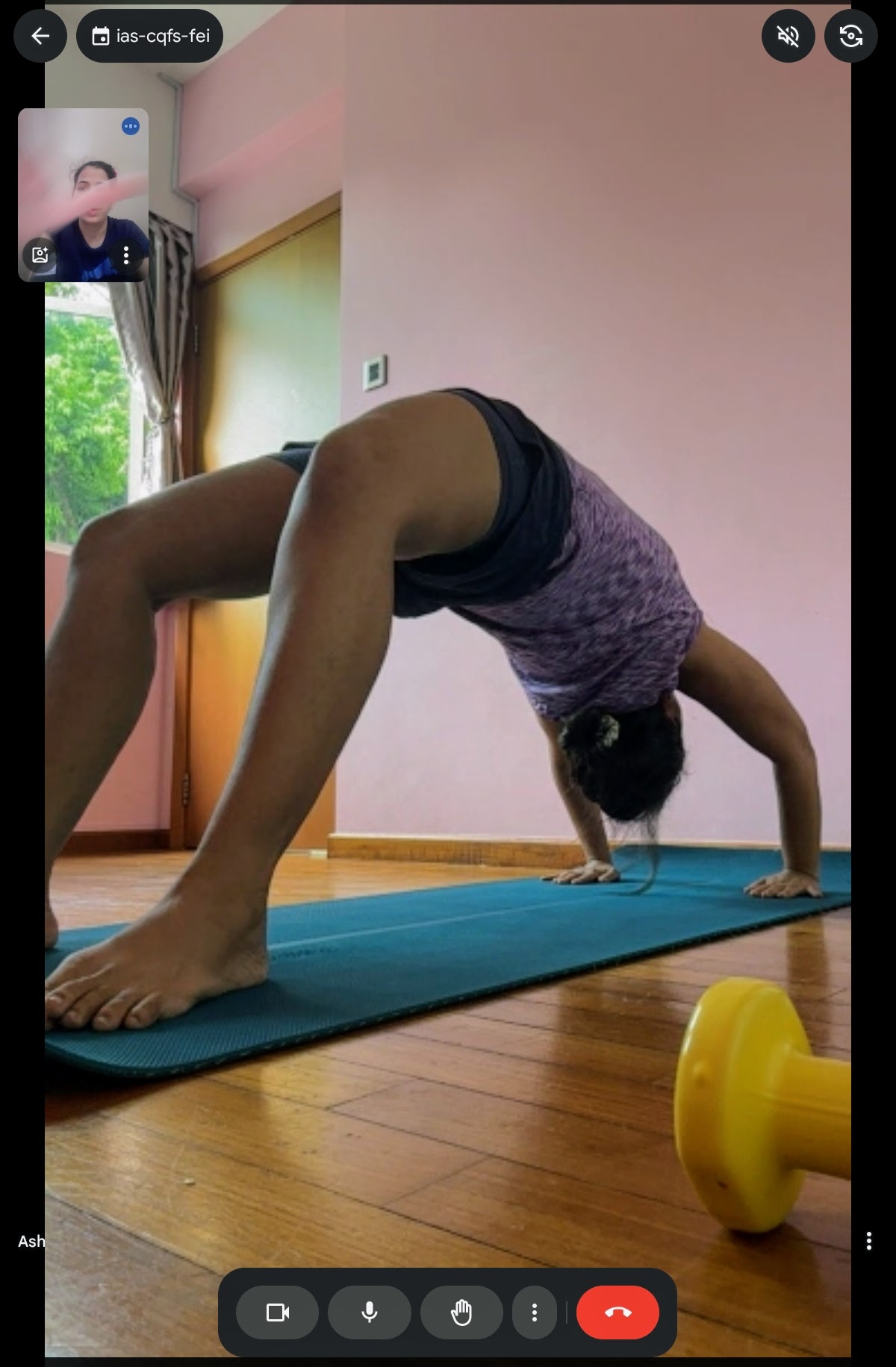 A student holding Chakrasana (Wheel Pose) during a virtual fitness session.